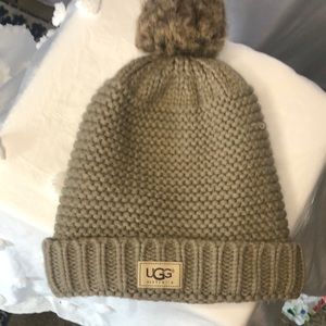 UGG AUSTRALIA taupe colored hat with pom Pom Pom on top.